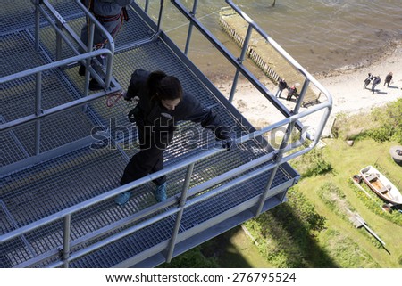 FREDERICIA, DENMARK - MAY 10, 2015: Bridgewalking Littlebelt. Official opening day. Crown Princess Mary  on the bridge and people under the bridge on beach.