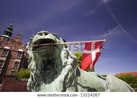 Lion and Flag in front of Royal Rosenborg Castle in Copenhagen, Denmark – Danish Crown Jewels are kept here. The castle was originally built as a country summerhouse – Year 1606.