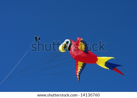 Parrot. Fantasy Kite High-Up in the Sky a Sunny Day on the Beach. Kite Flying Festival on Fanoe, Denmark.