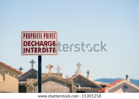 Propriete Privee, Decharge Interdite - French for  Private Area, No Unloading. Sign outside a cemetary on Corsica, France.