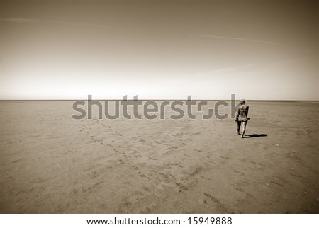 Low Tide Walk. Woman walking on Koresand,  Low Tide Island in Denmark