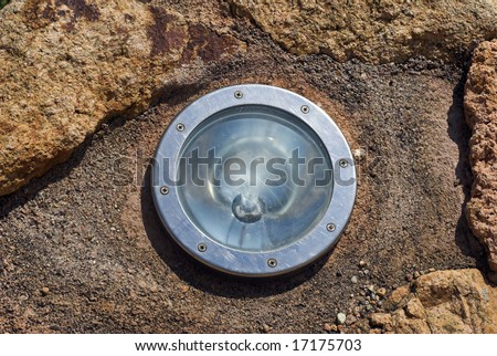Built-in Lamp. Round light source built in on rock close-up