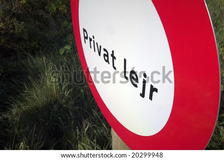 Private camp sign in red and white and in Danish language on private property