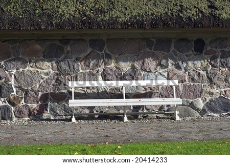 White Park Bench outside old cottage in Denmark