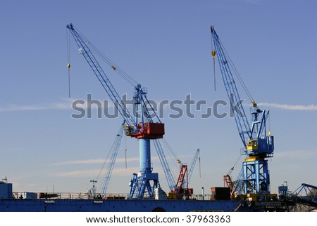 Two blue cranes in a German harbour.