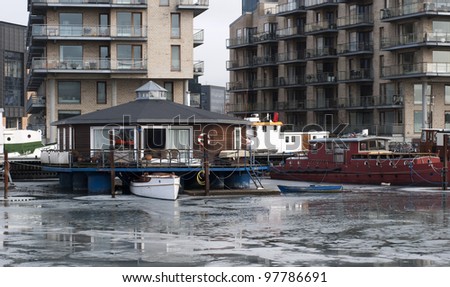 Houseboats and buildings close to a frozen canal in Copenhagen