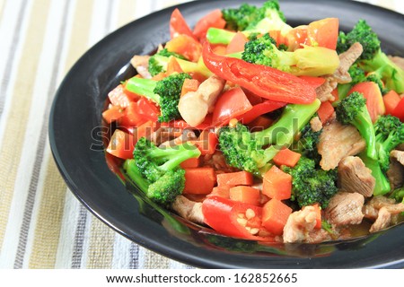 stir fried vegetables with pork in red dish./Fried vegetables.