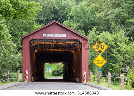 WEST CORNVALL, CONNECTICUT - JULY 15, 2015: The 1864 West Cornwall Covered Bridge. also known as Hart Bridge, is a wooden bridge over the Housatonic River on July 15, 2015 in West Cornwall, CT.