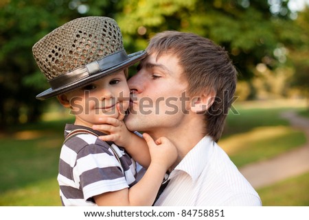 Happy daddy kissing the little son