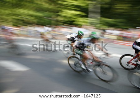 The cyclists riding by at the bicycle race Around Denmark 2006.