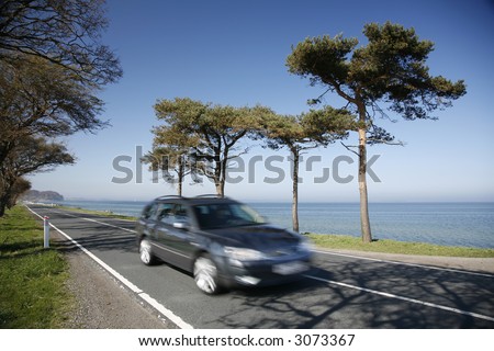 Speedy car along a coastal highway - Denmark - at springtime.