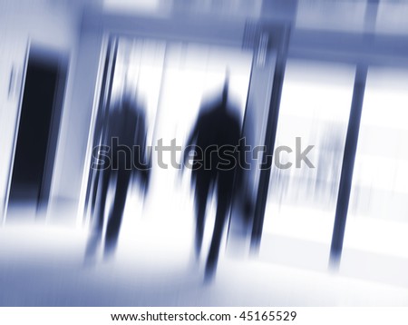 Business people hurrying to the next appointment. Zoom blur - space for text.