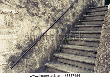 Nice old outdoor staircase Croatia. Image is cross processed to reflect age and time.