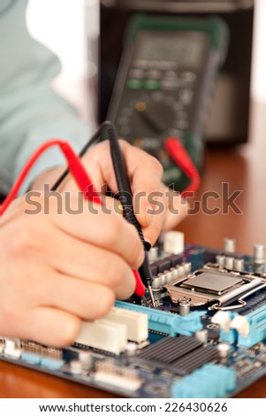 Technician repairing computer hardware in the lab .Small DOF