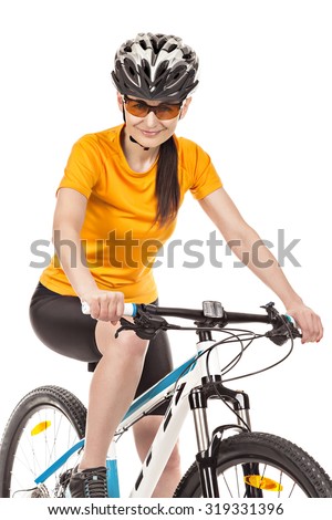 Portrait of a female cyclist dressed in sportswear, isolated on  white background  The woman sitting on the bike, looking at the camera and smiling. Studio shot.