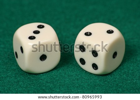 two dice on a green rug