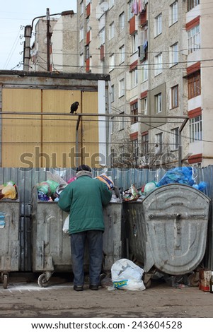 Ivano-Frankivsk, Ukraine - December 13, 2014:The person searches for something in garbage.