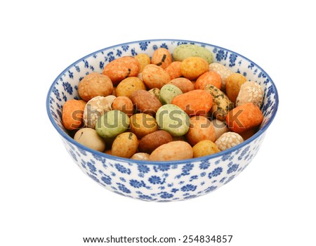 Seaweed peanuts in a blue and white porcelain bowl with a floral design, isolated on a white background