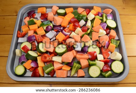 Chopped raw vegetables - red onion, butternut squash, red pepper, courgette, parsnip, green pepper, sweet potato - suitable for roasting