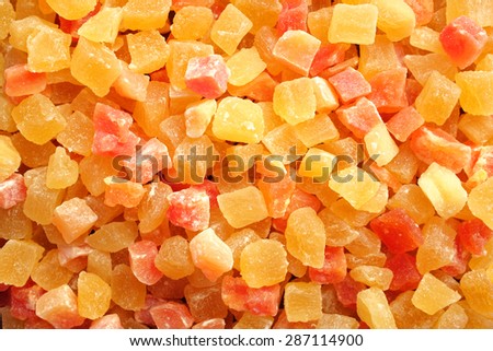 Dried pineapple and papaya pieces as an abstract background texture