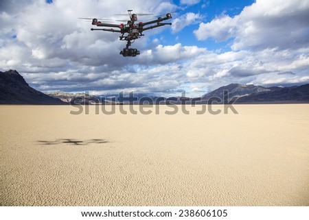 A flying helicopter with raised landing gears and a camera flying over mesmerizing view of Racetrack Playa