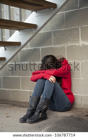 Teenage Girl Sitting Under Staircase In Alley-Way In A Depressed State ...