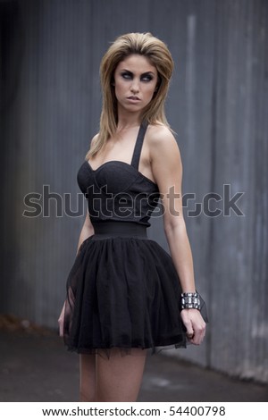 Outdoor photo of fashion model in little black dress