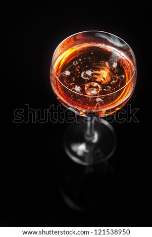 Red wine poured into translucent wine glass