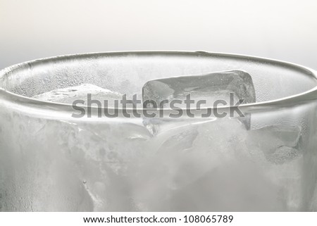 Glass of ice cubes without water, close up.
