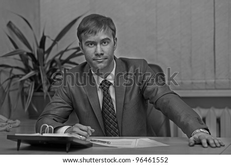 young businessman sitting at his office.Black and white.