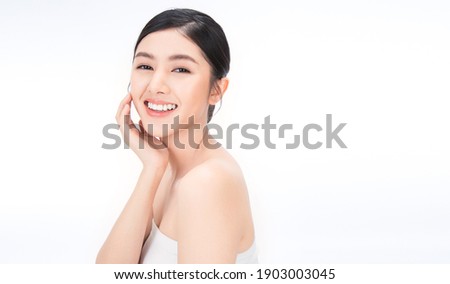 portrait of beauty asian woman with fair perfect healthy glow skin hand touching chin on white background, young beautiful asia girl with pretty smile face care. Beauty korean spa skincare.