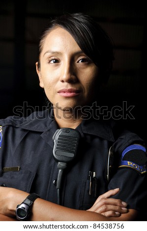a female police officer posing for her portrait at night.