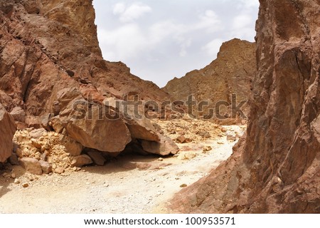 Tourist walk on a picturesque route in stone desert. Red sea, Israel