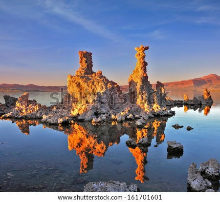 Mono Lake - a natural wonder in the United States. Outliers - bizarre limestone calcareous tufa formation  reflected in the smooth water.