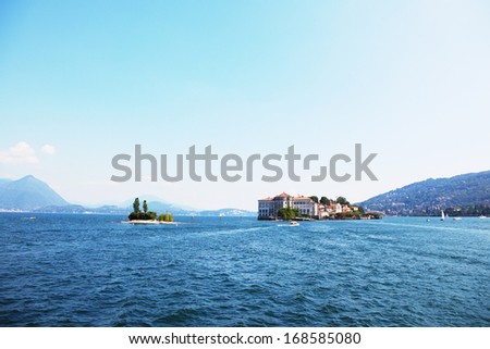 Charming little islands in Lake Maggiore, photographed with a tourist pleasure boat