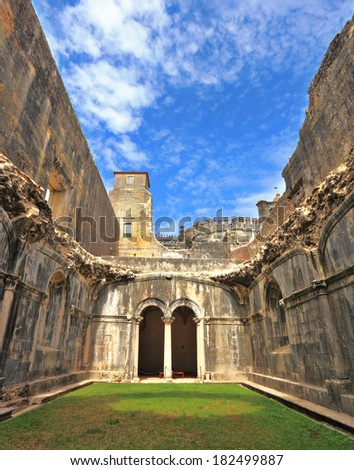 Palace of the Knights Templar in the small town of Tomar, Portugal. Beautiful green inner courtyard, surrounded by a fine building with a beautifully preserved architecture