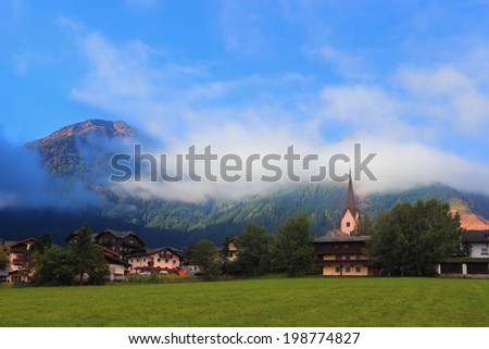 Charming Austrian province. Picturesque houses in mountain alpine meadows