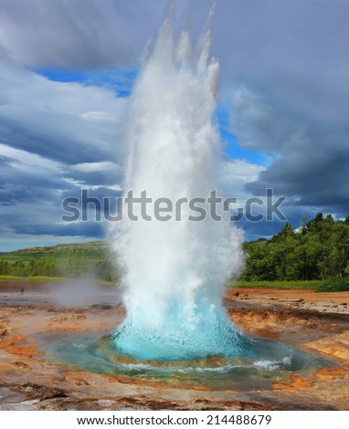 Summer in Iceland. Magnificent geyser Strokkur. The geyser throws out the fountain of azure water every few minutes