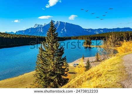 Similar – Image, Stock Photo Rocky mountains surrounding rippling sea under cloudy sky