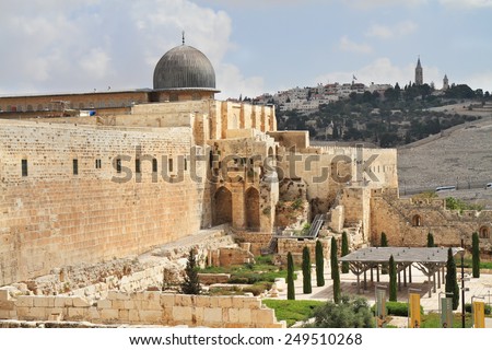 Gray dome of the Al-Aqsa Mosque on the Temple Mount in Jerusalem. The ancient walls of Jerusalem, lit morning sun.