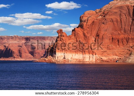 Walk on white boat on a sunny day. Scenic huge artificial water basin of the Colorado River, USA. Lake Powell is surrounded by magnificent sandstone hills