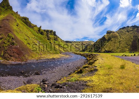 Canyon Pakgil in Iceland. Picturesque basalt hills overgrown green grass and polar moss. On a bottom of a canyon many streams flow