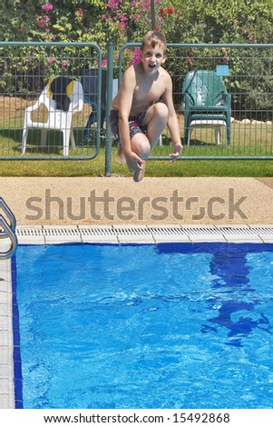 The boy with pleasure jumps in pool with pure transparent water