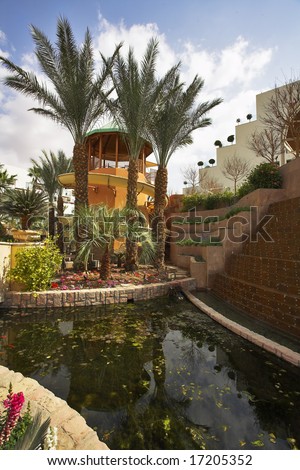 A magnificent fountain and a tower for descent in pool in a court yard of fine hotel