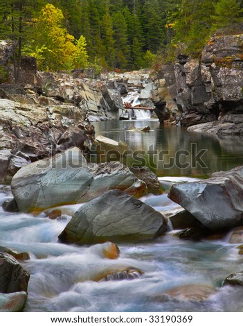 Cold stream in an autumn mountain wood