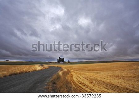 Thunder-storm above Montana. Fields after a harvest and road