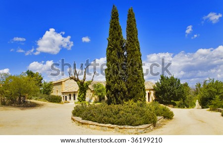 Rural hotel and cypresses in vicinities of ancient city Toledo