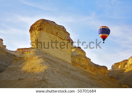 Huge balloon above ancient mountains of the Dead Sea. A sunset
