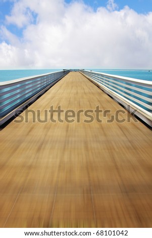 Fast trip on a wooden pier at Pacific coast USA. Warm serene autumn day