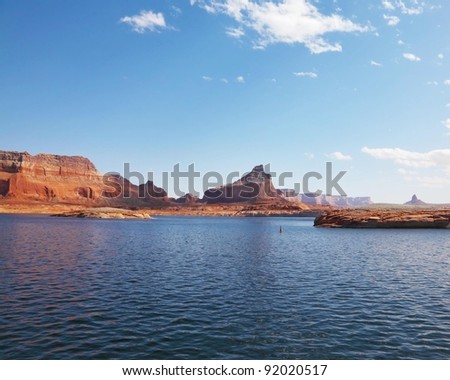 Magnificent Lake Powell. Picturesque red cliffs reflected in the smooth water of the lake